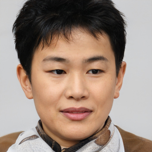 Joyful asian young-adult male with short  brown hair and brown eyes