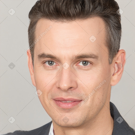 Joyful white adult male with short  brown hair and brown eyes