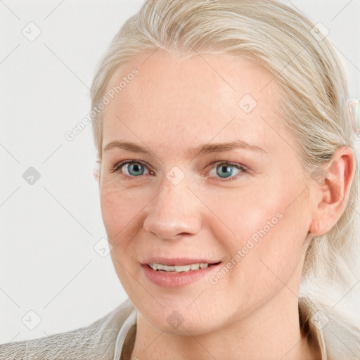 Joyful white young-adult female with long  brown hair and blue eyes