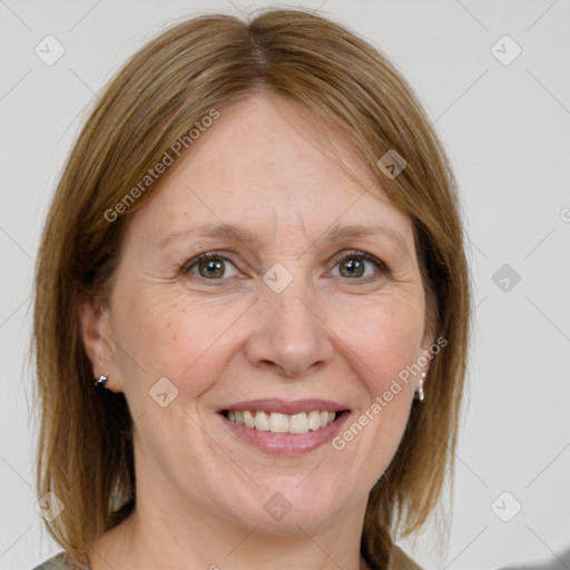 Joyful white adult female with medium  brown hair and grey eyes