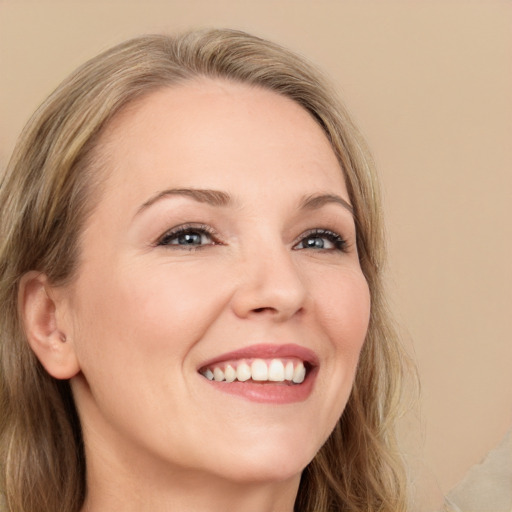 Joyful white young-adult female with long  brown hair and green eyes