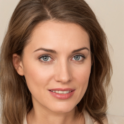 Joyful white young-adult female with medium  brown hair and green eyes