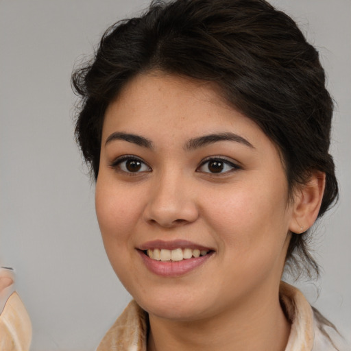 Joyful latino young-adult female with medium  brown hair and brown eyes