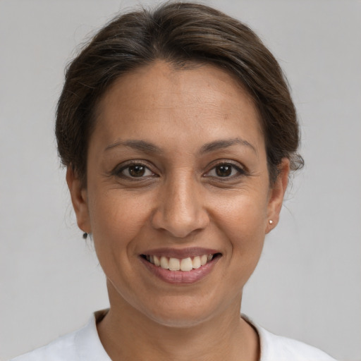 Joyful white adult female with medium  brown hair and brown eyes