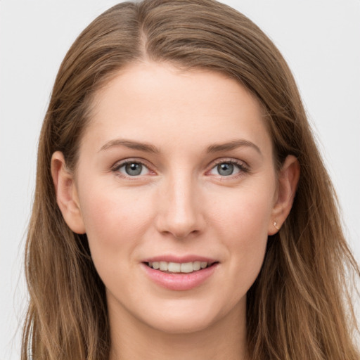 Joyful white young-adult female with long  brown hair and grey eyes