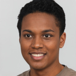 Joyful black young-adult male with short  black hair and brown eyes