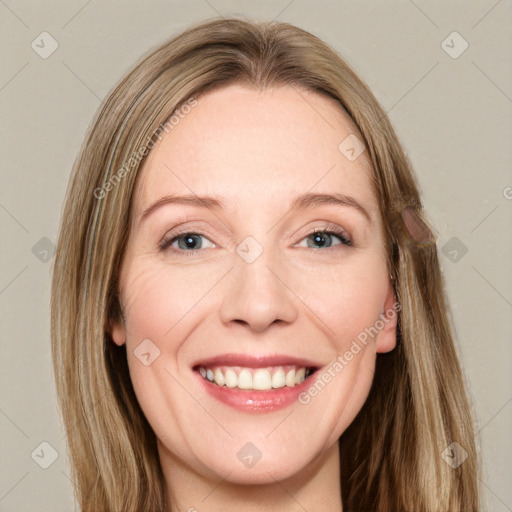 Joyful white young-adult female with long  brown hair and green eyes