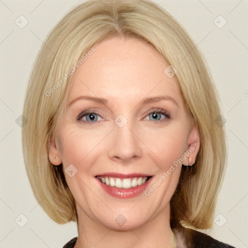 Joyful white adult female with medium  brown hair and blue eyes