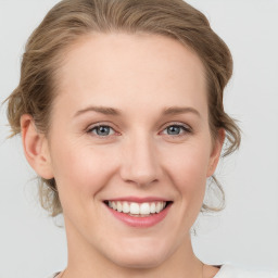 Joyful white young-adult female with medium  brown hair and blue eyes