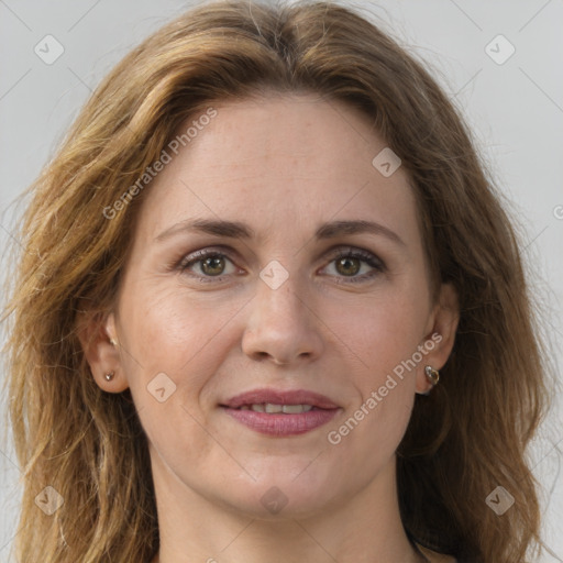 Joyful white adult female with long  brown hair and brown eyes