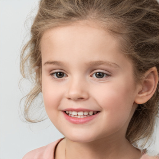 Joyful white child female with medium  brown hair and brown eyes