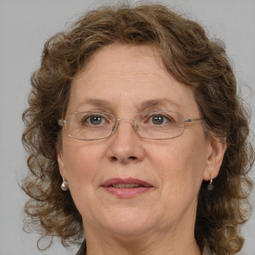 Joyful white middle-aged female with medium  brown hair and grey eyes