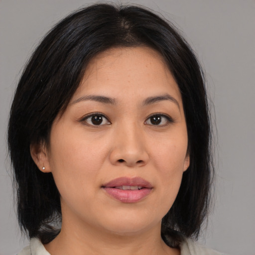 Joyful asian young-adult female with medium  brown hair and brown eyes