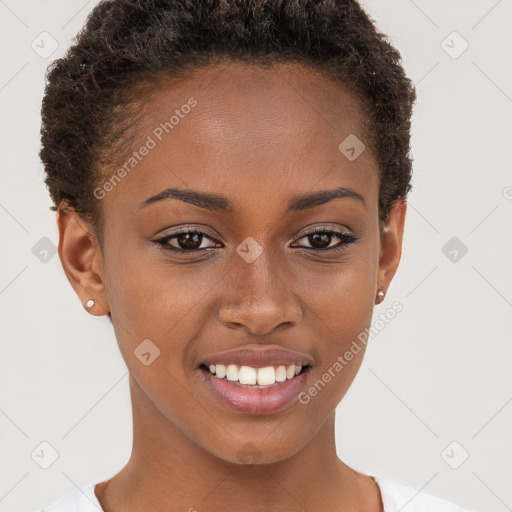 Joyful black young-adult female with short  brown hair and brown eyes