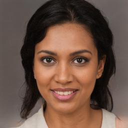 Joyful black young-adult female with medium  brown hair and brown eyes