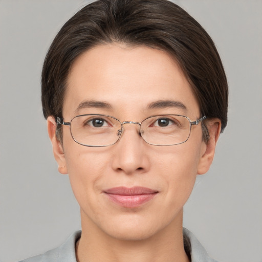 Joyful white adult female with short  brown hair and grey eyes