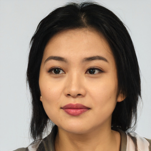 Joyful asian young-adult female with medium  black hair and brown eyes