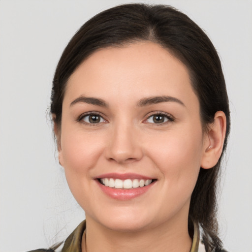 Joyful white young-adult female with medium  brown hair and brown eyes