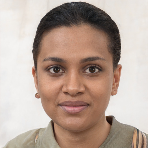 Joyful black young-adult female with short  brown hair and brown eyes