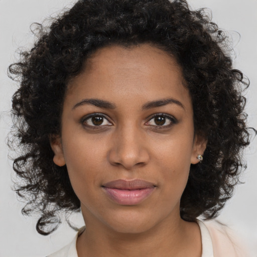 Joyful black young-adult female with medium  brown hair and brown eyes