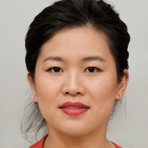 Joyful asian young-adult female with medium  brown hair and brown eyes