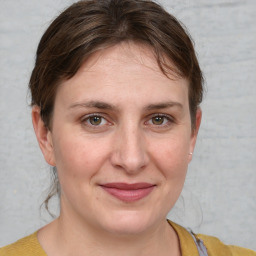 Joyful white adult female with medium  brown hair and grey eyes