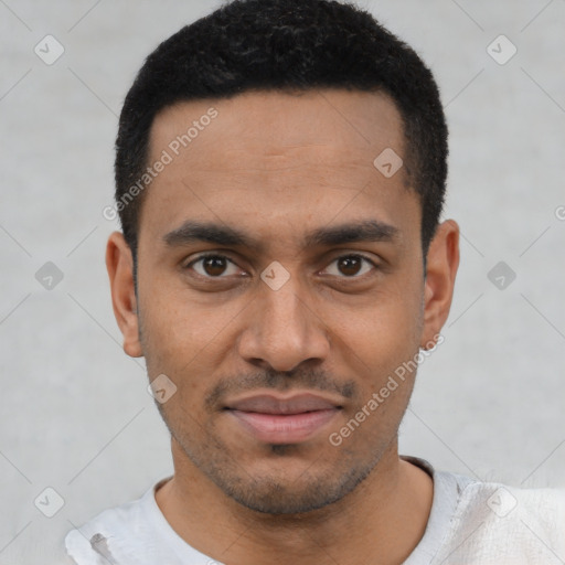 Joyful latino young-adult male with short  black hair and brown eyes