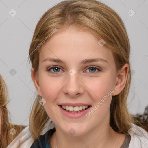 Joyful white young-adult female with medium  brown hair and blue eyes