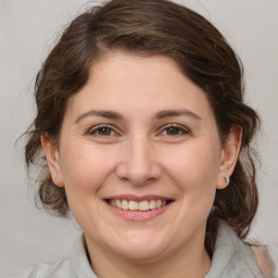 Joyful white adult female with medium  brown hair and brown eyes