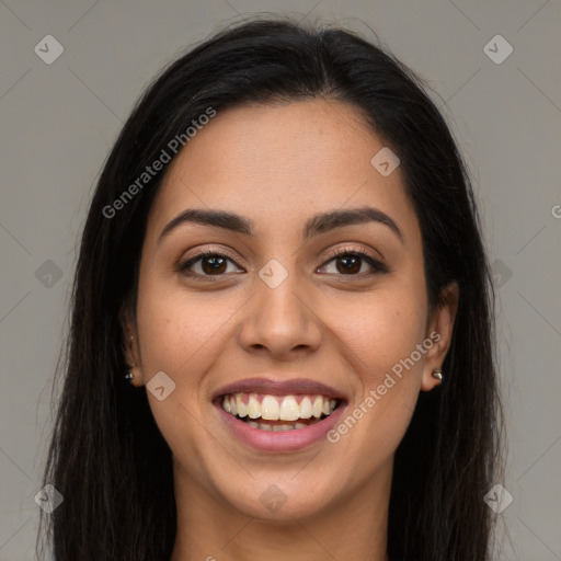 Joyful latino young-adult female with long  brown hair and brown eyes