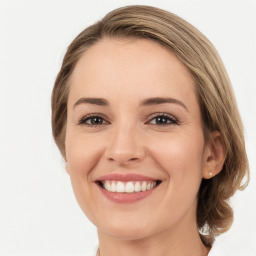 Joyful white young-adult female with medium  brown hair and green eyes