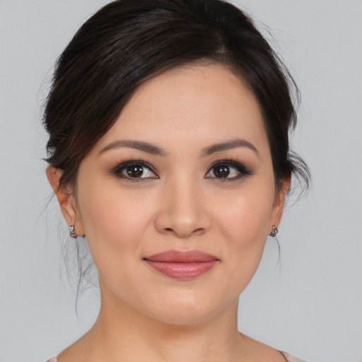Joyful asian young-adult female with medium  brown hair and brown eyes