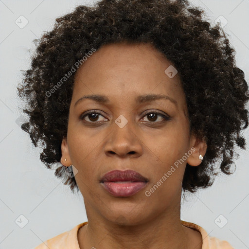 Joyful black adult female with short  brown hair and brown eyes