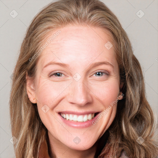 Joyful white adult female with long  brown hair and blue eyes