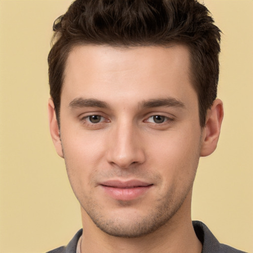 Joyful white young-adult male with short  brown hair and brown eyes