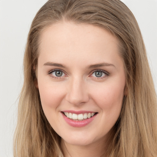 Joyful white young-adult female with long  brown hair and green eyes