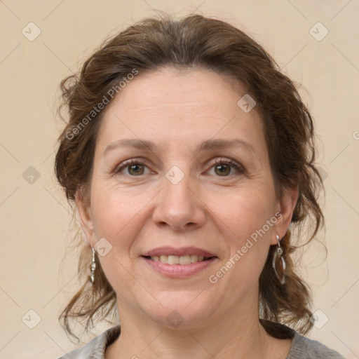 Joyful white adult female with medium  brown hair and grey eyes