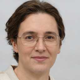 Joyful white adult female with short  brown hair and grey eyes