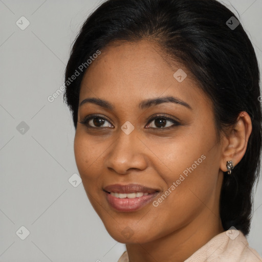 Joyful black young-adult female with long  brown hair and brown eyes