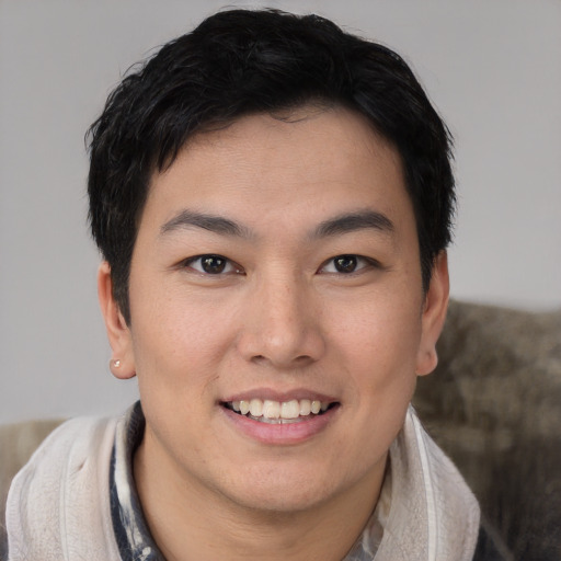 Joyful asian young-adult female with short  black hair and brown eyes