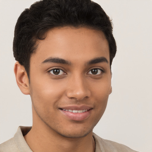 Joyful latino young-adult male with short  brown hair and brown eyes