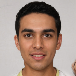 Joyful white young-adult male with short  black hair and brown eyes