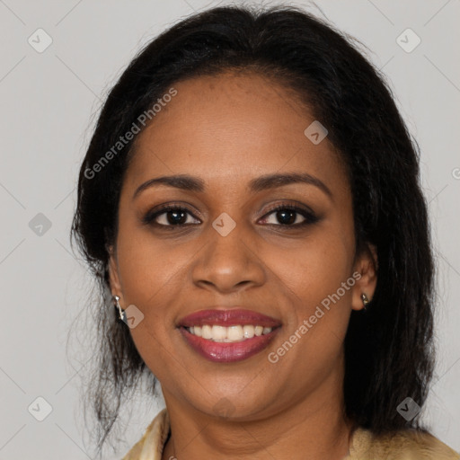 Joyful black young-adult female with long  brown hair and brown eyes