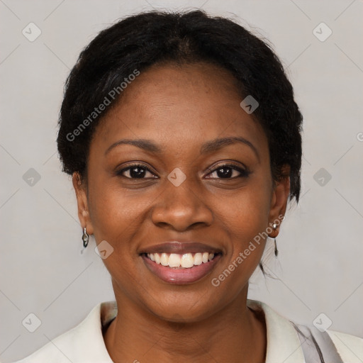 Joyful black young-adult female with short  brown hair and brown eyes