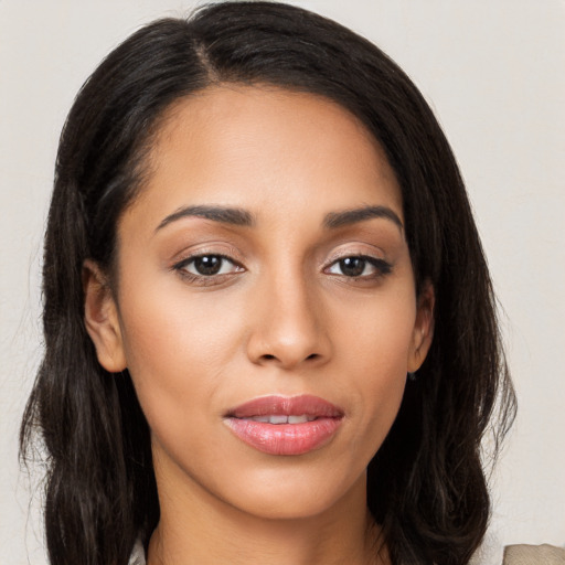 Joyful latino young-adult female with long  brown hair and brown eyes