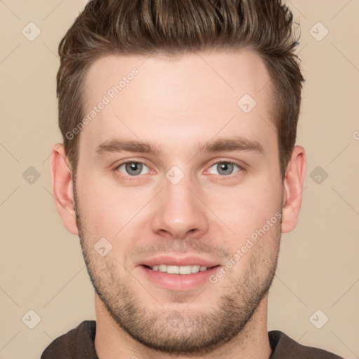 Joyful white young-adult male with short  brown hair and grey eyes