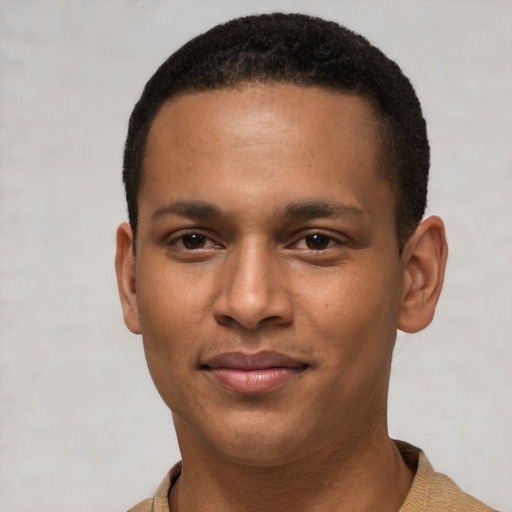 Joyful latino young-adult male with short  brown hair and brown eyes