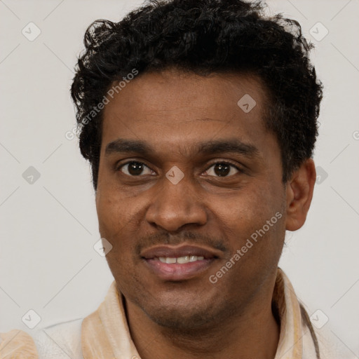 Joyful black young-adult male with short  brown hair and brown eyes