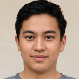 Joyful asian young-adult male with short  black hair and brown eyes