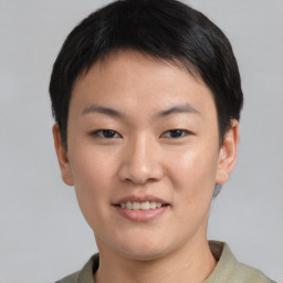 Joyful asian young-adult female with short  black hair and brown eyes